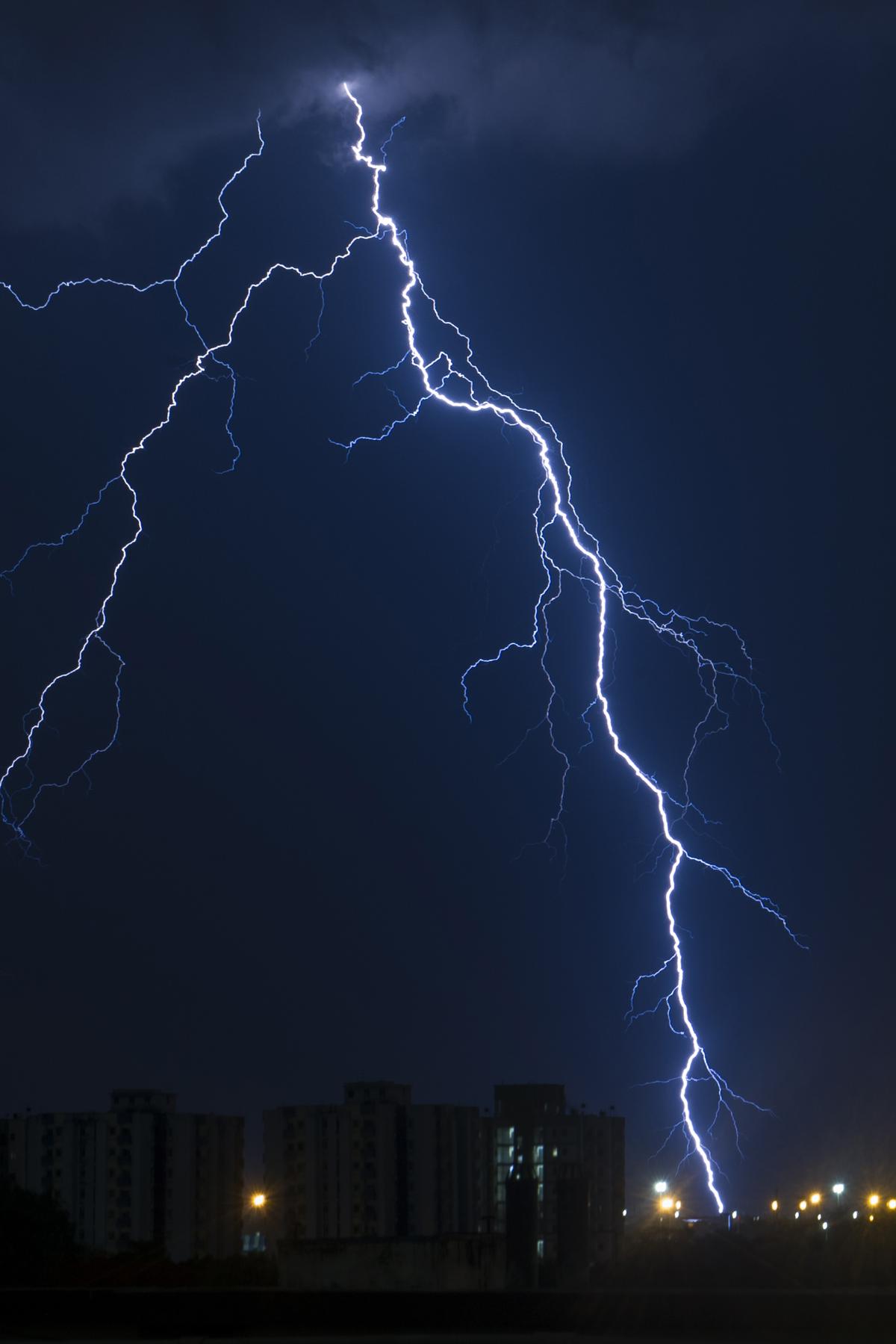 A jagged bolt of lightning tears across the monsoon sky over Kolkata.